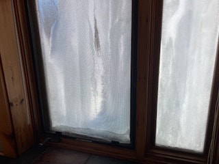 The outside of the windows in a water damaged home in Lake George are caked with ice.