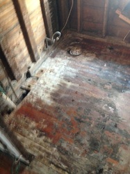 Bathroom gutted down to the studs during water damage restoration.