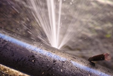 water spurting out of a metal pipe