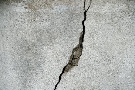 cement wall with a large diagonal crack