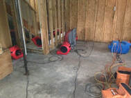 Drying equipment making garage apartment dry after pipe burst to prevent water damage