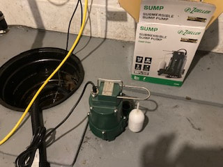 Sump pump being installed in a previously flooded basement in Amsterdam, NY.