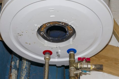 bottom of a water heater that appears to be leaking