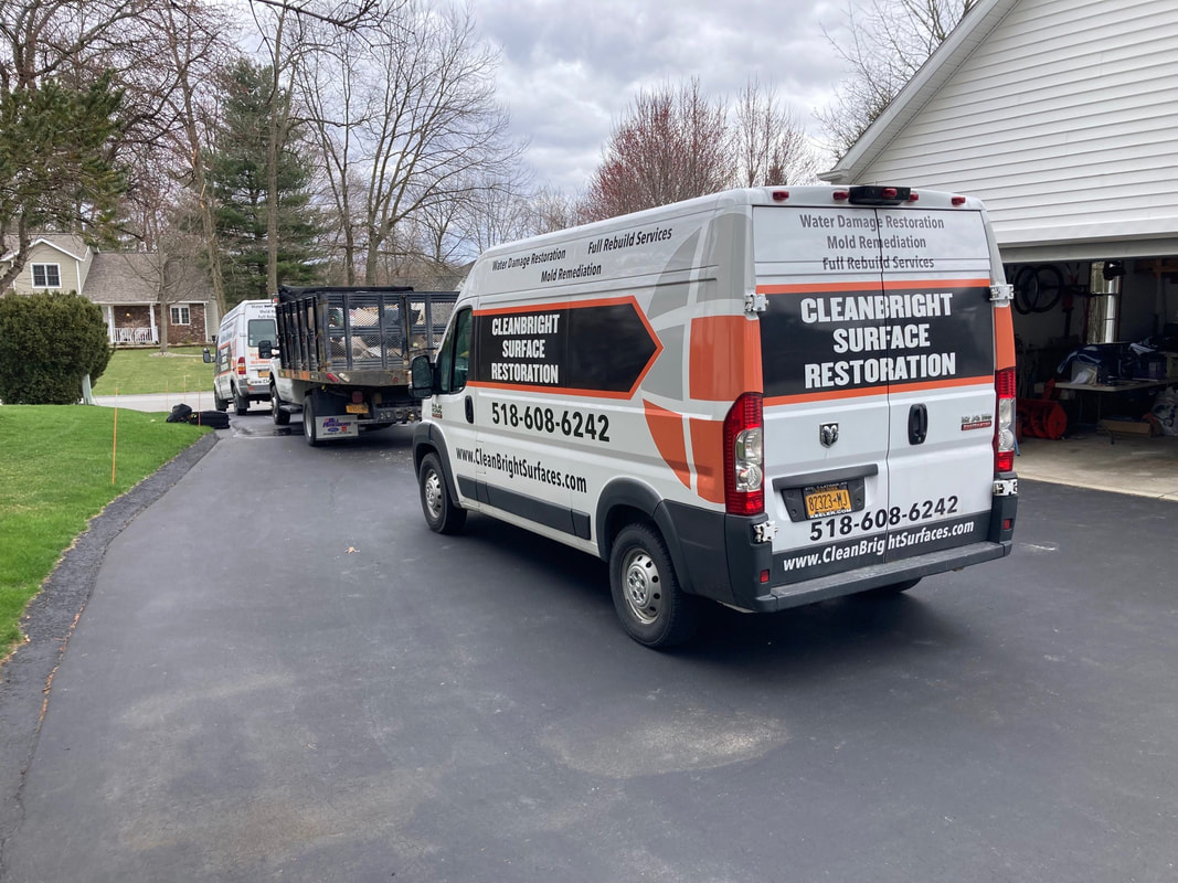 CleanBright Surface Restoration trucks at the scene of a water damage job in Halfmoon, NY