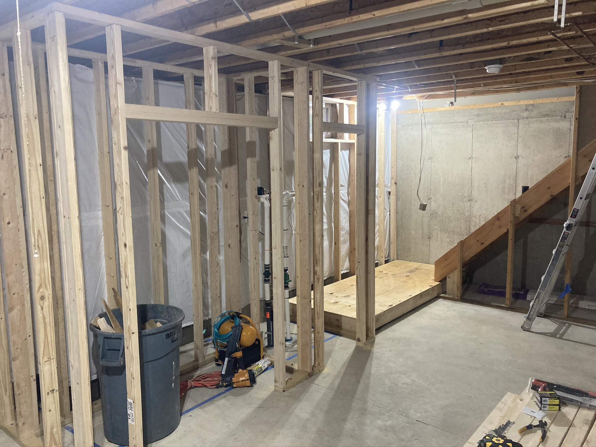 New stud walls being framed in a basement during reconstruction